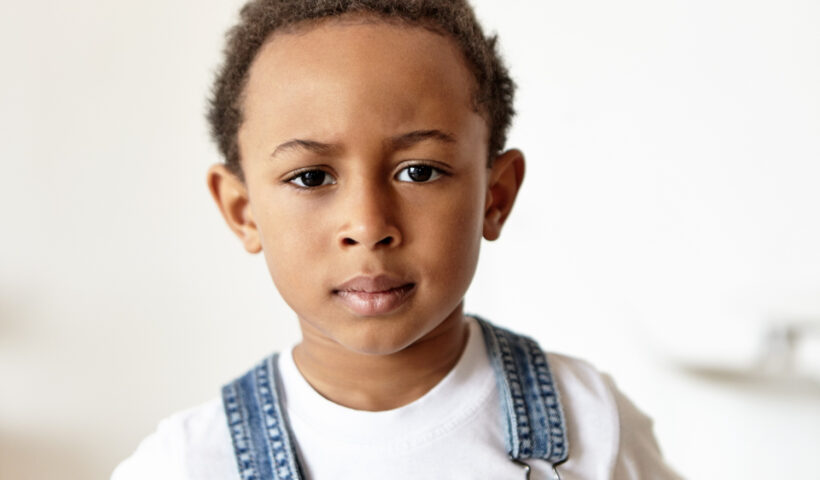 grumpy-cute-little-boy-african-appearance-dressed-denim-jumpsuit-white-t-shirt