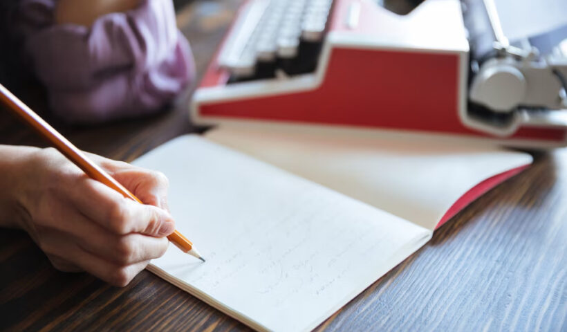 portrait-female-hand-holding-pencil-open-notebook_171337-19300