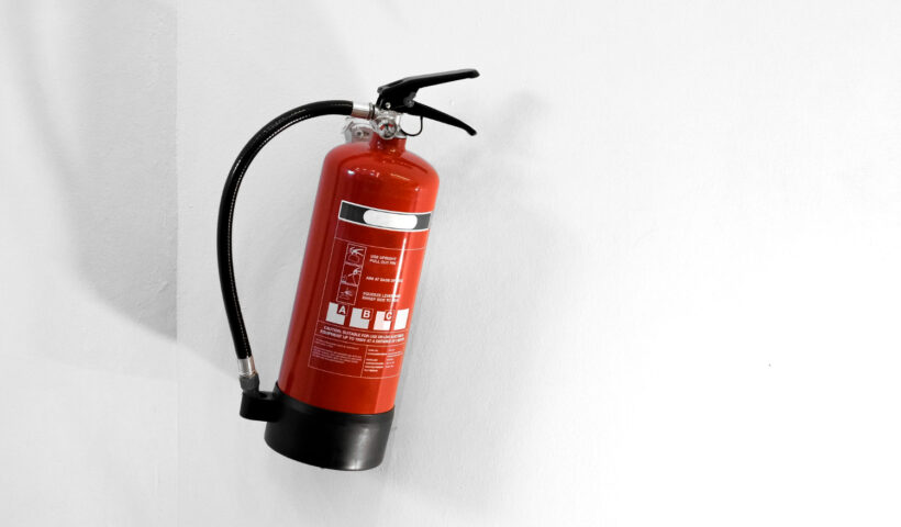 red-fire-extinguisher-white-wall