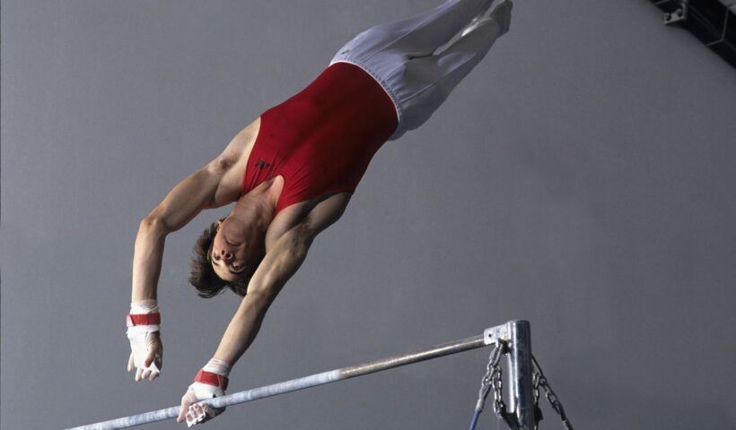 male-gymnast-performing-on-the-high-bar-78233718-5c51060e46e0fb000180a6e4