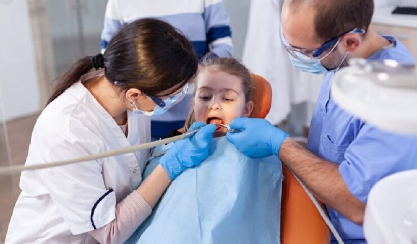 little-girl-with-mouth-open-course-cavity-treatment-sitting-dental-chair-mother-with-her-kid-stomatology-clinic-teeth-examine-using-modern-instruments_482257-12130