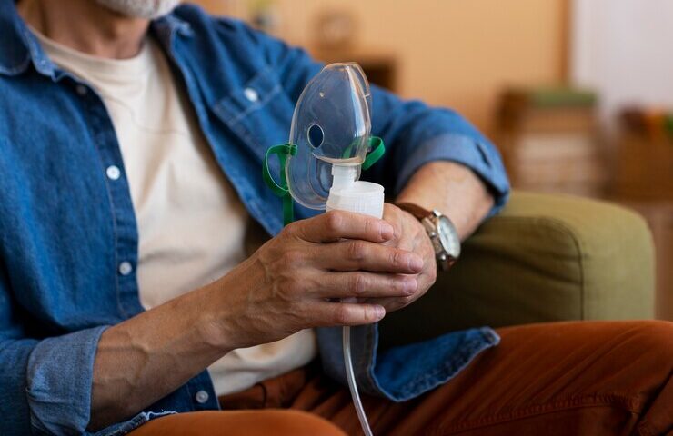 front-view-man-using-nebulizer_23-2150535975
