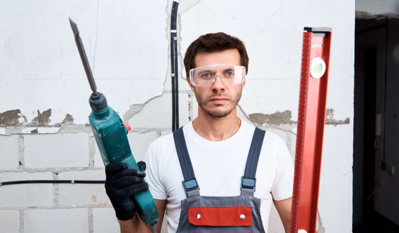 worker-man-with-hammer-drill-and-building-level-at-2022-12-16-12-46-38-utc (1)