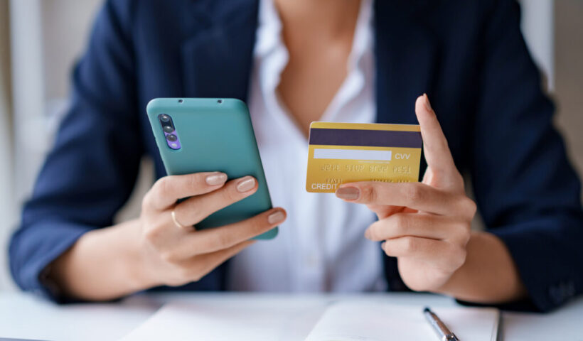 young-woman-using-a-credit-card-through-1024x683